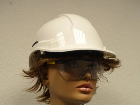 Mannequin wearing a hard hat and safety glasses